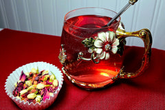 A shot of my Strawberry Moonrise tea in loose leaf form with a steeped version in the glass next to it.