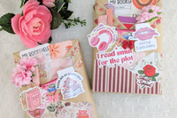 surprise book box with new book, annotation supplies, relaxation and self care items packaged neatly in a box