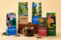 Multiple bags of coffee and cup of coffee, part of Goodbirds monthly coffee subscription of 2 12oz bags of coffee