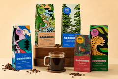 Multiple bags of coffee and cup of coffee, part of Goodbirds monthly coffee subscription of 2 12oz bags of coffee