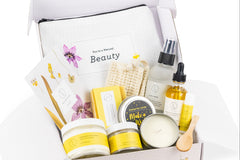 All-natural bath and body gift box featuring a variety of citrus-scented products, including soap, body oil, body scrub, shower steamer mist
