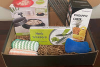 A subscription box full of different kitchen gadgets that are used for cooking, meal prep, or clean up.