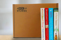 Brown box filled with fiction books, showcasing a variety of gripping titles and intriguing covers, perfect for mystery lovers.