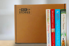 Brown box filled with fiction books, showcasing a variety of gripping titles and intriguing covers, perfect for mystery lovers.