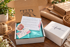Tranquil Rose Deluxe Serenity gift box wrapped in elegant teal tissue paper with a thank-you seal and luxury presentation.    