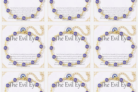 Nine 14K gold plated evil eye bracelets displayed on white 'The Evil Eye' gift cards, each with blue evil eye charms on a gold-tone chain.