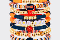 Game Day 8-piece stackable friendship bracelet set in navy blue, orange, white, and gold beads with football, helmet, and GAME DAY letter ch