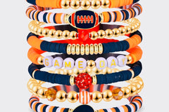 Game Day 8-piece stackable friendship bracelet set in navy blue, orange, white, and gold beads with football, helmet, and GAME DAY letter ch