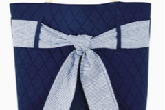 Navy quilted handbag with rope handles and a blue and white striped nautical bow.  A fabulous accessory for spring and summer.