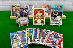 Kansas City Royals baseball cards arranged in display stands on a green carpet and with a brick background.