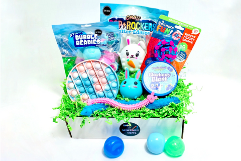 Colorful fidget toys including OMG Pop Rocker and Stretchy Worms in a subscription box for tweens and kids