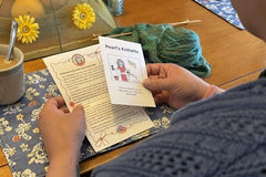 Knit Snail Mail club member with her letter. Each month's mailing includes a letter, cartoon, cookie recipe and fun suprises.