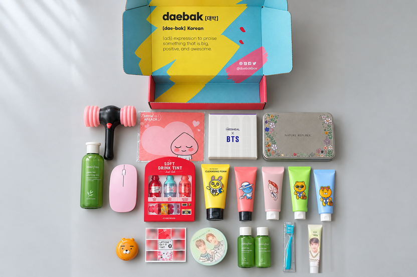 A past season's Deluxe box laid out: Mediheal x BTS masks, Nature Republic tin, innisfree green tea set, Kakao Friends tubes and more