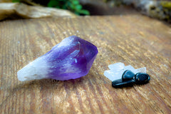 Enchanted Crystal subscription box on wooden table, with single featured crystal of the month and bonus mini crystals
