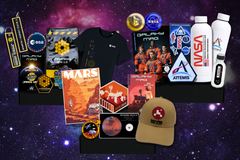 Open space subscription box displaying astronomy-themed gifts, cosmic collectibles, accessories, and educational items.