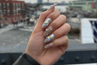 You Make My Heart Chromed set. Almond shape, medium length. Nude nails with pearls and white/silver glitter. Silver chrome with holo hearts.