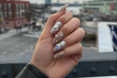 You Make My Heart Chromed set. Almond shape, medium length. Nude nails with pearls and white/silver glitter. Silver chrome with holo hearts.