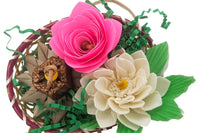 A flower themed bird toy. Made up of a variety of textures, including papers, sola, palm, and mahogany. Mostly naturally colored 