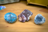 Enchanted Crystal Kids Crystal Box with three crystal varieties on display on a wooden table with a felt tray in the background