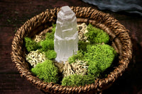 example of a product that may be included: four inch tall selenite tower in a decorative wooden basket with moss