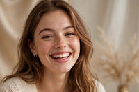 model shown is laughing with cream themed attire with a glowing face giving the i use glowing skincare effect. 
