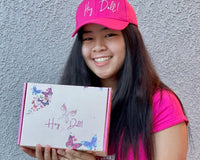 One of our Dolls glowing with pure joy and delight as she holds her box of joy, confidence and excitement.