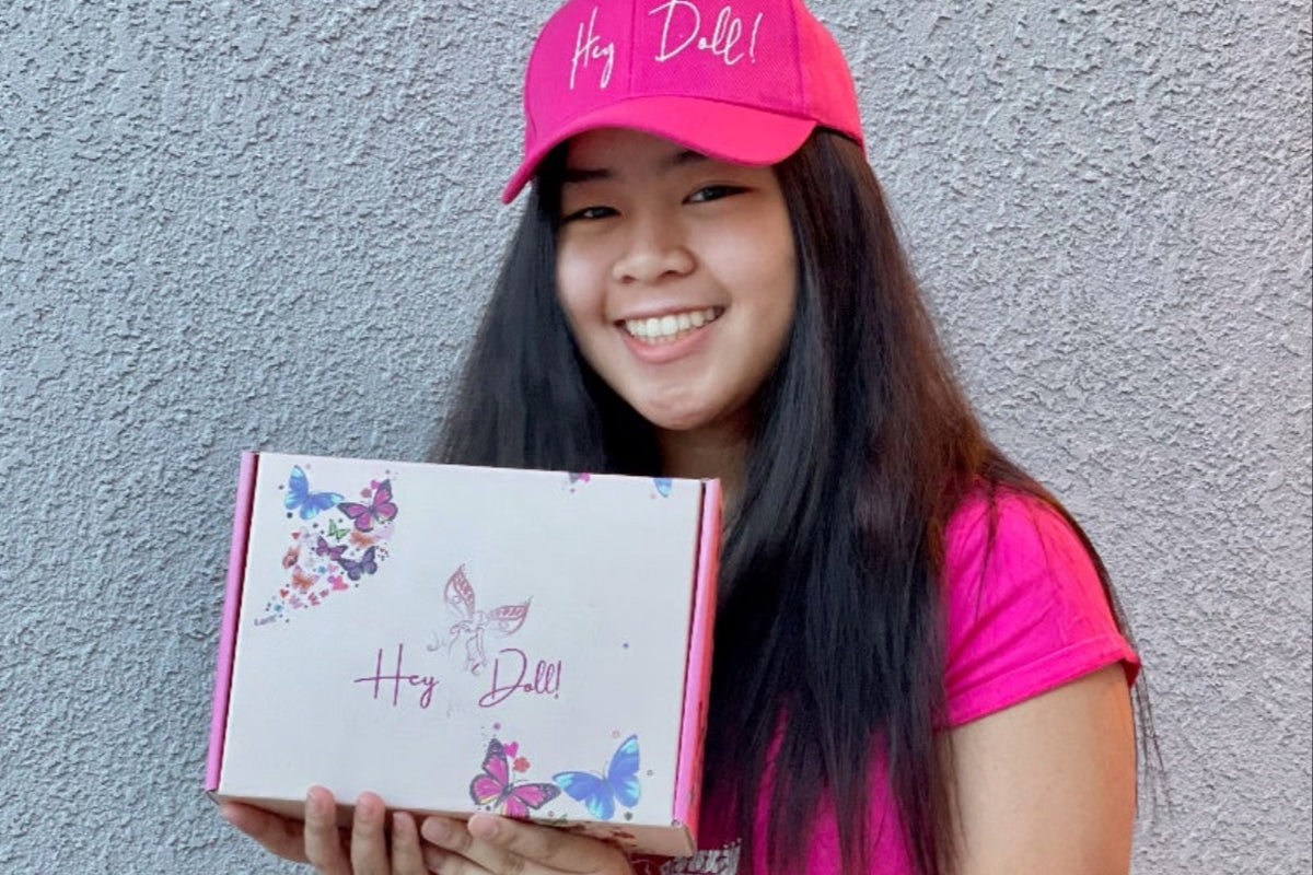 One of our Dolls glowing with pure joy and delight as she holds her box of joy, confidence and excitement.