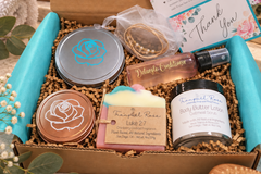 Tranquil Rose spa gift box featuring handcrafted soaps, body care, botanical products and elegant packaging for self-care.