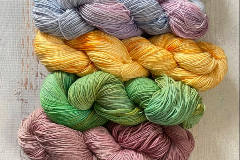 100% merino wool.  Four of six skeins shown 