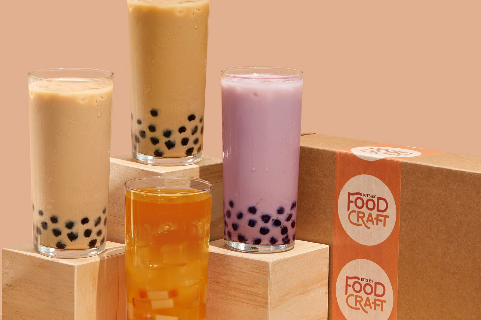 Four homemade bubble tea drinks, including classic milk tea, taro milk tea, brown sugar tea, and fruit tea served with chewy tapioca pearls 
