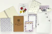 Box Overview / Flat Lay items. Custom name notepad from personalized stationery subscription set with themed design