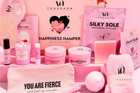 Skin care, wellness and spa gift box from the brand yoguenow. All with pink and purple colors and some other products.