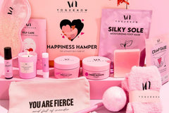 Skin care, wellness and spa gift box from the brand yoguenow. All with pink and purple colors and some other products.