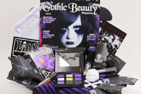 Gothic Beauty subscription box featuring magazine, goth-themed accessories, and spooky goodies arranged in a decorative package