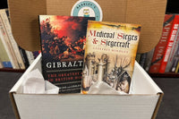 A book box containing two hardcover books: Gibralter and Medieval Sieges and Siegecraft, as an example of what might be sent.