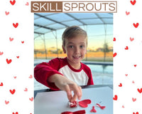 Happy child with February Activity Box. February Valentine's box with 20 OT activities, crafts, sensory materials, and fine motor tools for 