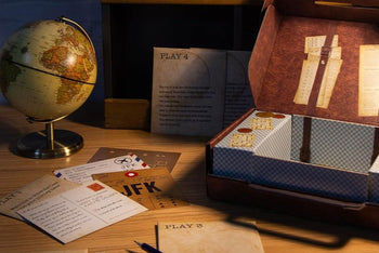 High quality photo of a box with mystery escape game called the JFK and with a globe sitting next to it as decoration.