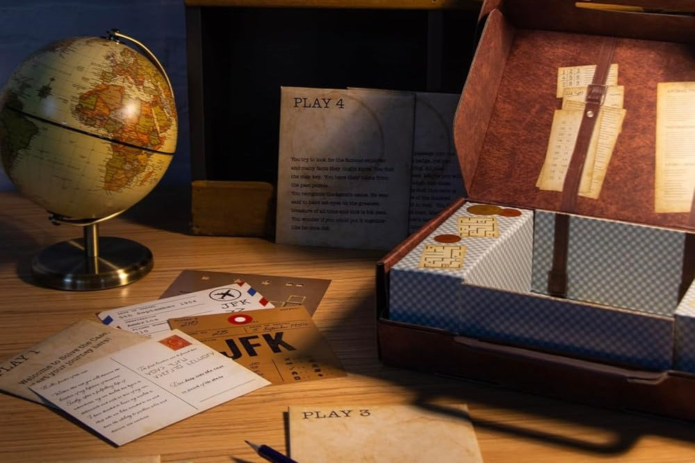 High quality photo of a box with mystery escape game called the JFK and with a globe sitting next to it as decoration.