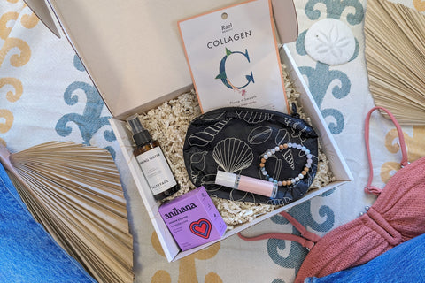 The open Palm People subscription box shows the following products: shower steamer, bracelet, small bag, tanner, perfume, and face mask.