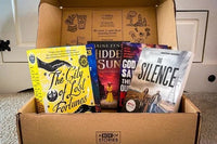 Brown subscription box filled with four fantasy novels, featuring magical worlds and adventurous plots for fans of imaginative storytelling