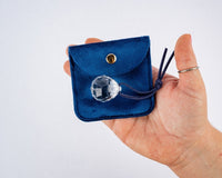 A bright prism held in a hand, one of the sensory treasures from Tía’s Box of Treasures that encourages play and discovery.