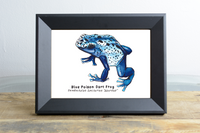 Beautiful Nature Sketch Crate watercolor and ink Blue Poison Dart Frog framed in a black frame on a wooden shelf.