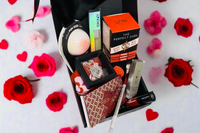 10 piece monthly beauty, spa, fragrance, jewelry and makeup box with an assortment of premium brands displayed with red roses 