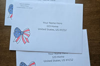 Three white envelopes with printed sample U.S. mailing addresses and red, white and blue patriotic bow designs with stars and stripes.
