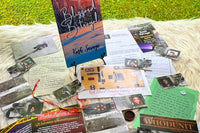 Sample of one of our previously released mysteries Blizzard Betrayal shown on a table with the journal, evidence, and clues on a table.