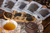 A hand pours tea from a kettle into a cup beside a Tea Runners subscription box and loose leaf tea packages