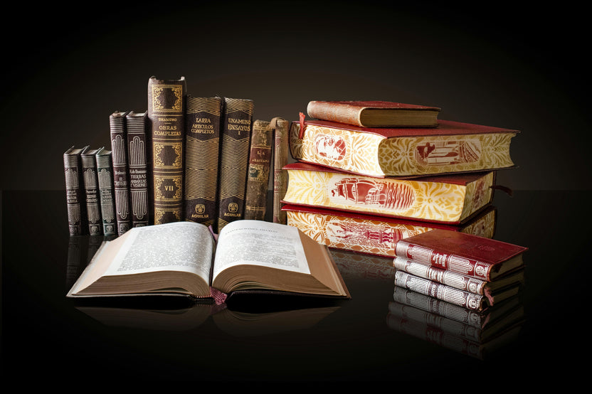 A person holding an open hardcover book with red edges, showcasing a cozy reading moment for book lovers with the Fantasy Books Club subscription