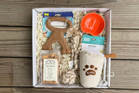 Box includes:
One full size bag dog treats,
One Chew Toy
One Plush/Rope/Ball
One themed gift for the human 
