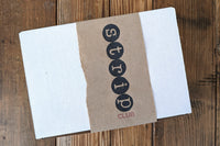 Strip Club Subscription Box shown closed with Strip Club Logo printed on a Kraft paper box sleeve with torn edges.