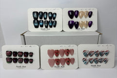 Display cards showing multiple sets of press-on nails in different colors and designs, neatly arranged to showcase variety in styles, shapes
